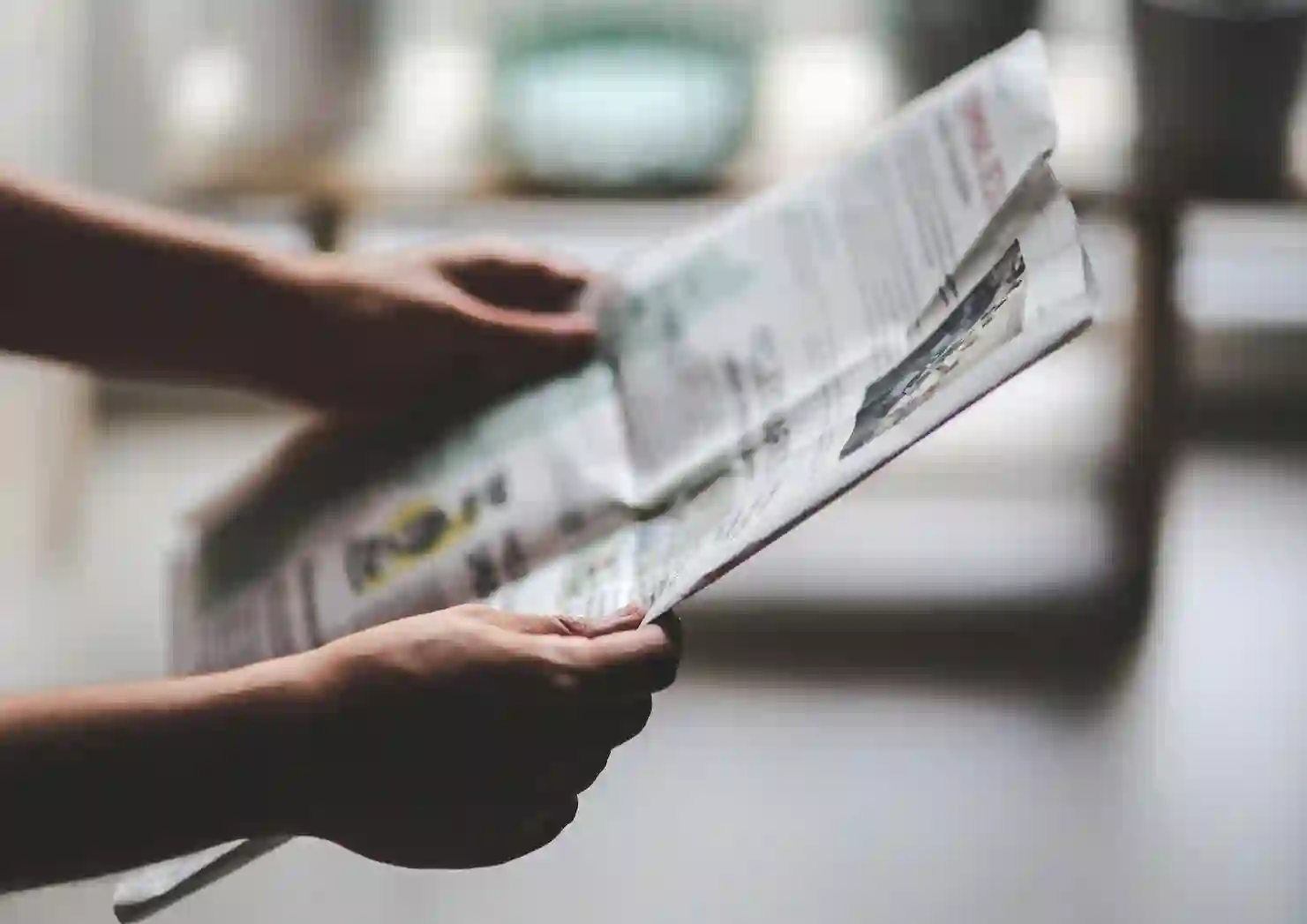 Canva-Man-reading-newspaper